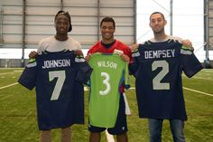 Eddie Johnson (left), formerly of the Seattle Sounders, Russell Wilson (middle) QB of the Seattle Seahawks, and Clint Demsey (right), current captain of the  Sounders all pictured together.