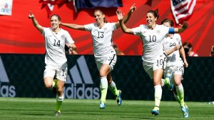 Morgan Brian #14, Carli Lloyd #13, and Alex Morgan #10 celebrate an early goal in the US' victory over Japan on Sunday.